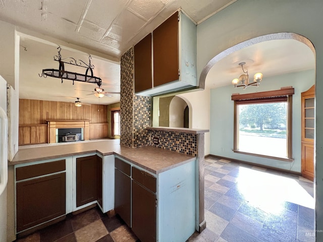 278 Taylor St, Twin Falls, ID 83301 - kitchen with ceiling fan, tasteful backsplash, a chandelier, open floor plan, and arched walkways