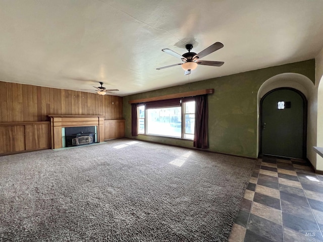 278 Taylor St, Twin Falls, ID 83301 - unfurnished living room with a ceiling fan, wooden walls, and arched walkways