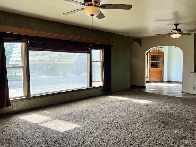 278 Taylor St, Twin Falls, ID 83301 - unfurnished room with arched walkways, ceiling fan, carpet floors, and baseboards