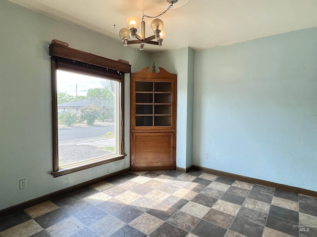 278 Taylor St, Twin Falls, ID 83301 - unfurnished dining area featuring a chandelier, baseboards, and stone finish floors
