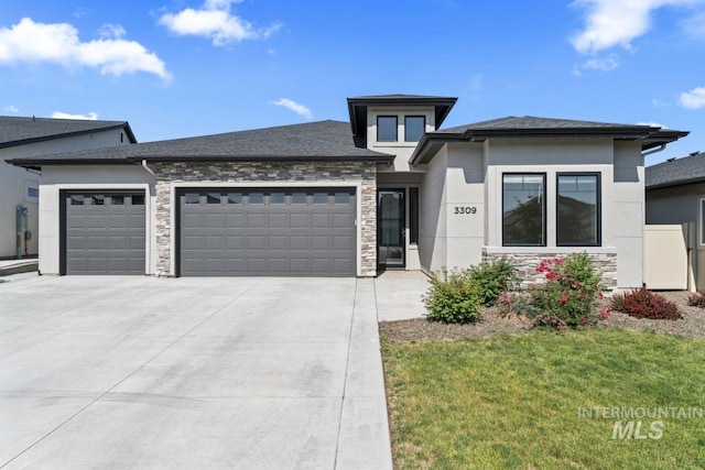 3309 S Humility Pl, Meridian, ID 83642 - prairie-style home with a garage, stucco siding, driveway, stone siding, and a front lawn