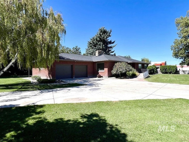 view of front of property with a garage and a front yard