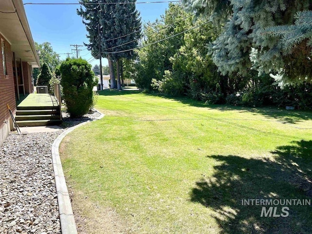 view of yard featuring a wooden deck