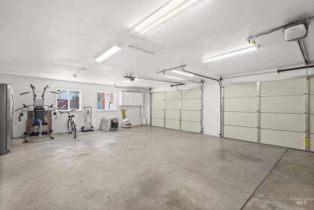3413 Bluebird Cir, Lewiston, ID 83501 - garage with a garage door opener and freestanding refrigerator