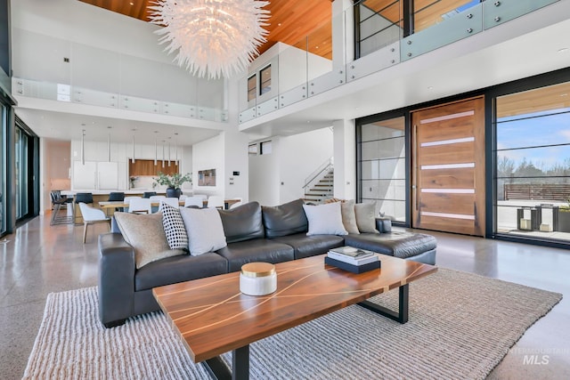 living room with a chandelier and a high ceiling