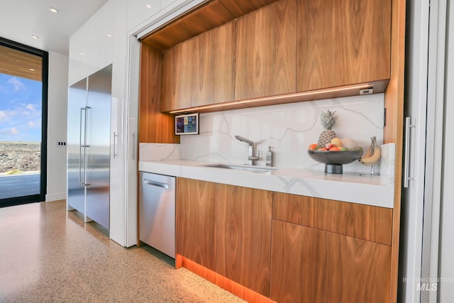 kitchen featuring sink, dishwasher, and backsplash