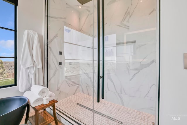 bathroom with tile walls and an enclosed shower