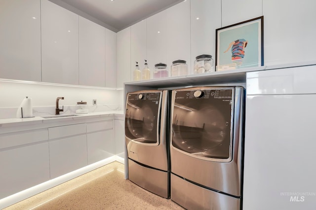 washroom with independent washer and dryer and sink