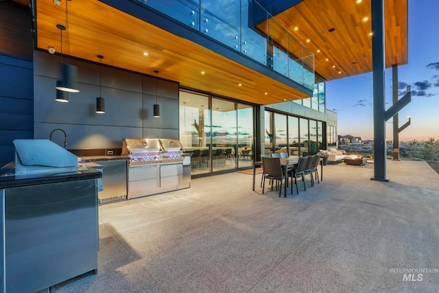 patio terrace at dusk with area for grilling