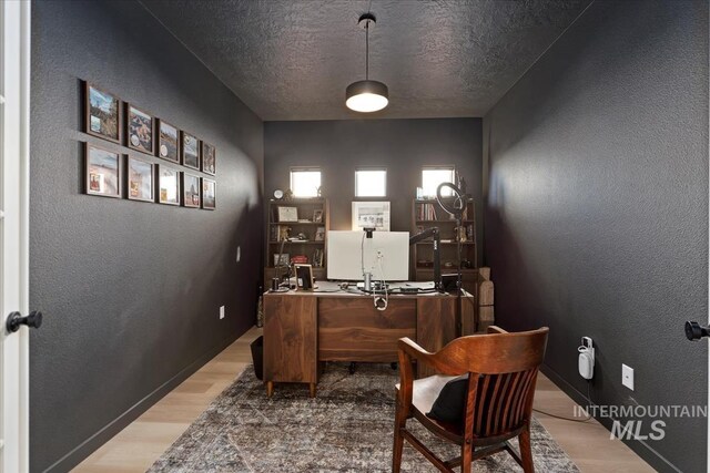 19321 Geneva Way, Caldwell, ID 83605 - office with a textured wall, a textured ceiling, and light wood-style flooring