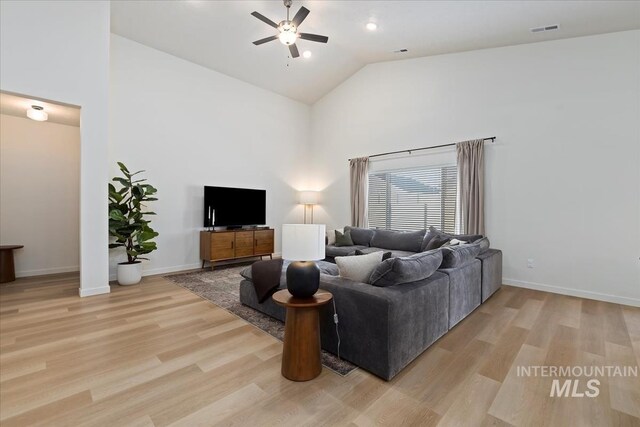 19321 Geneva Way, Caldwell, ID 83605 - living area featuring light wood-style floors, visible vents, a ceiling fan, and high vaulted ceiling