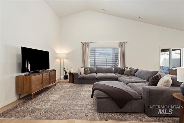 19321 Geneva Way, Caldwell, ID 83605 - living room with high vaulted ceiling, baseboards, wood finished floors, and visible vents