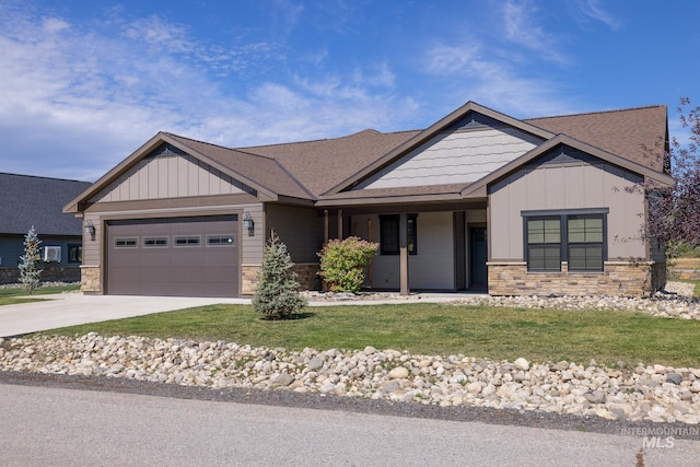 craftsman house with a garage and a front lawn