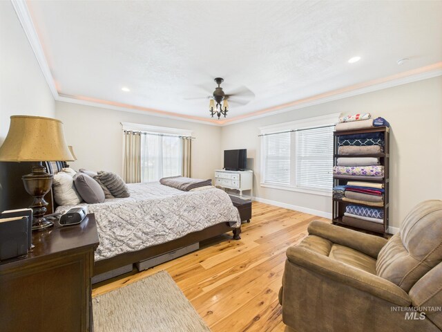 bedroom with multiple windows, crown molding, hardwood / wood-style flooring, ceiling fan, and recessed lighting