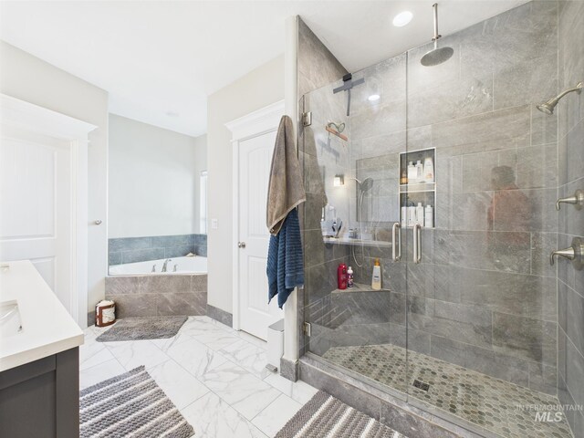 full bath with a garden tub, a stall shower, marble look tile flooring, and vanity