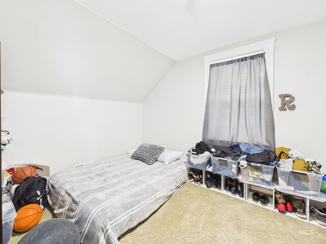 carpeted bedroom featuring vaulted ceiling