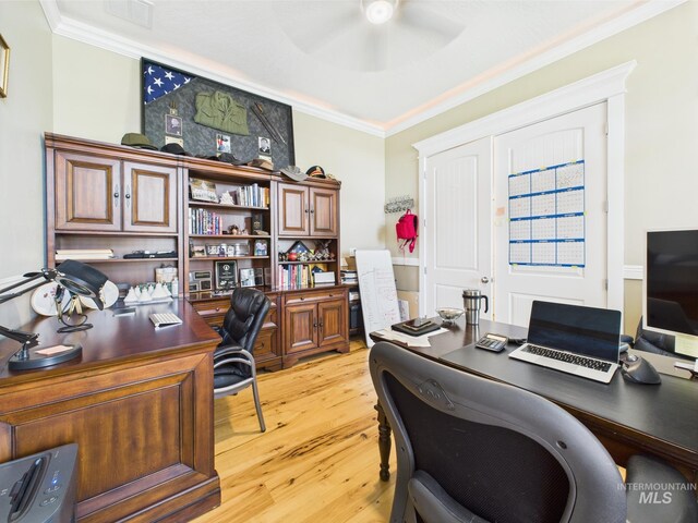 home office featuring ceiling fan, crown molding, and light wood-style floors