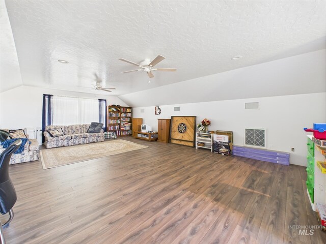recreation room with lofted ceiling, wood finished floors, a textured ceiling, and a ceiling fan