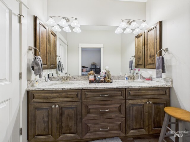 bathroom with double vanity and connected bathroom