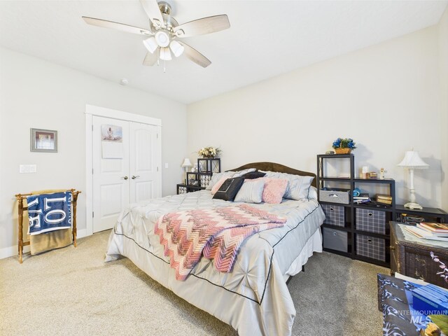 carpeted bedroom featuring a closet and a ceiling fan