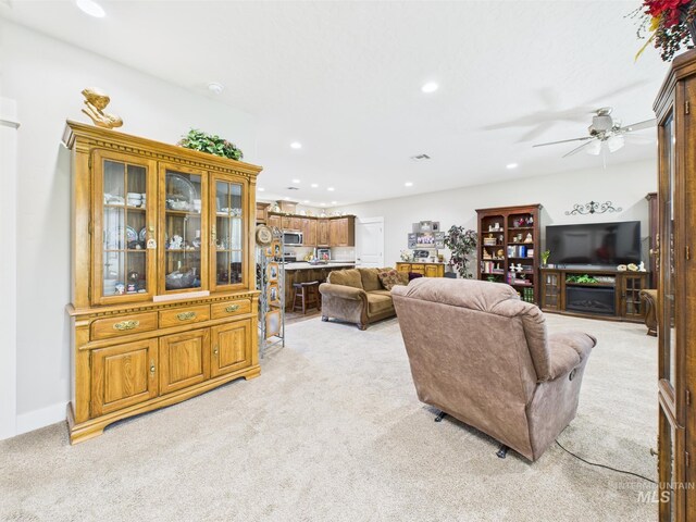 living room featuring light carpet, recessed lighting, and ceiling fan