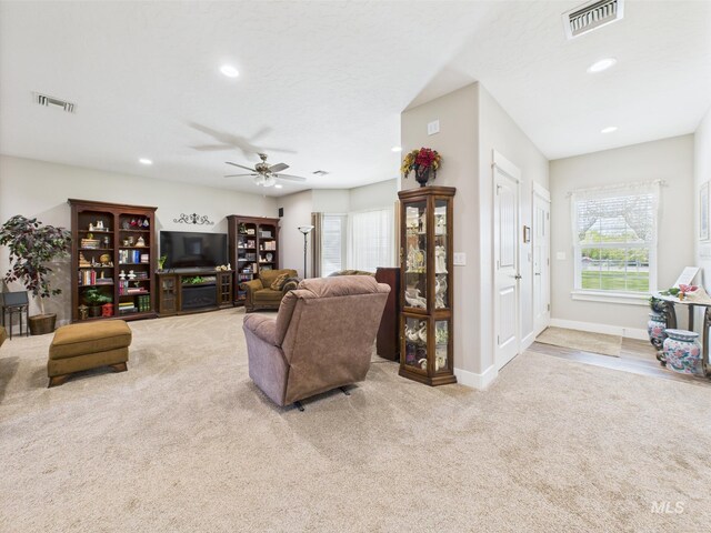 carpeted living room featuring ceiling fan, recessed lighting, and baseboards