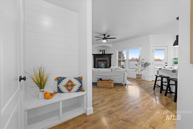 living room with hardwood / wood-style floors and ceiling fan