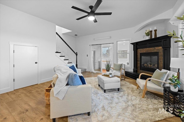 living room featuring ceiling fan and light wood-type flooring