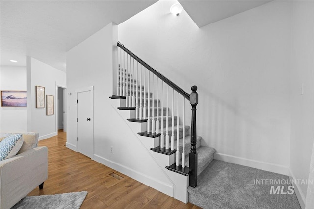 staircase featuring hardwood / wood-style flooring