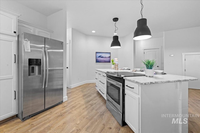 kitchen featuring white cabinetry, a center island, hanging light fixtures, light hardwood / wood-style flooring, and appliances with stainless steel finishes