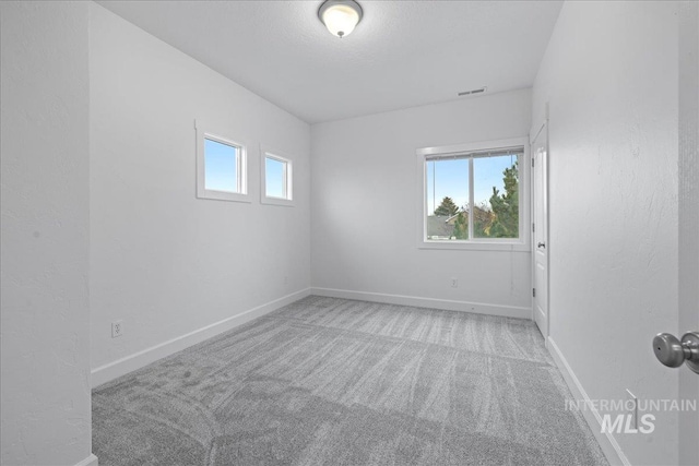 empty room featuring light colored carpet