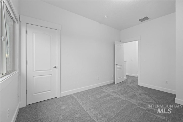 unfurnished bedroom featuring carpet floors and a closet