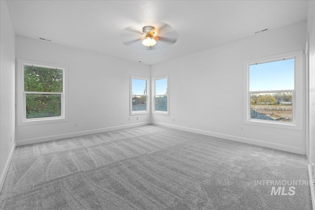 empty room with light carpet and ceiling fan