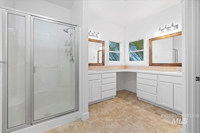 bathroom with vanity and walk in shower