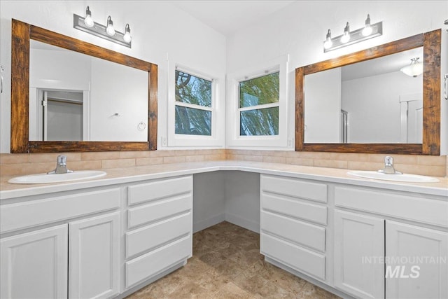 bathroom featuring decorative backsplash and vanity