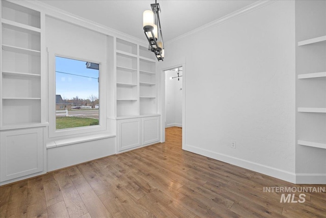 unfurnished dining area featuring crown molding and light hardwood / wood-style floors