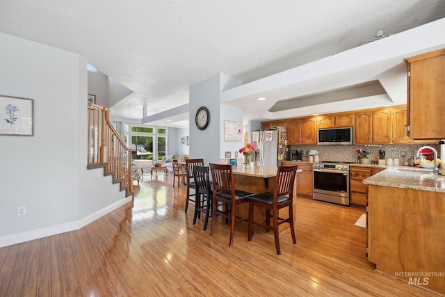 1229 N Hiltonhead Way, Eagle, ID 83616 - dining room with baseboards, light wood-style floors, stairway, and a raised ceiling