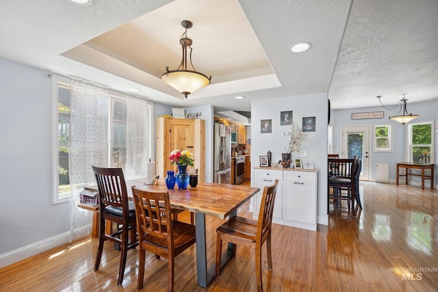 1229 N Hiltonhead Way, Eagle, ID 83616 - dining room with healthy amount of natural light, light wood-type flooring, baseboards, recessed lighting, and a tray ceiling