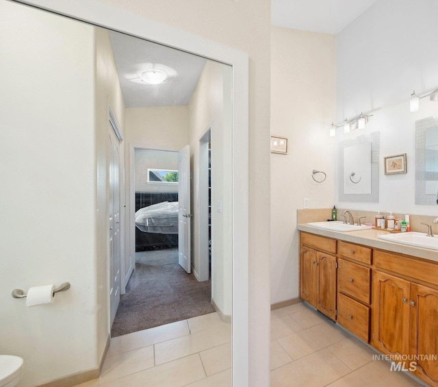1229 N Hiltonhead Way, Eagle, ID 83616 - ensuite bathroom with double vanity, tile patterned flooring, toilet, and baseboards