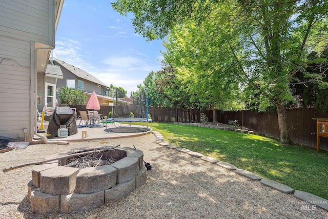 1229 N Hiltonhead Way, Eagle, ID 83616 - view of yard featuring an outdoor fire pit, a trampoline, and a patio area