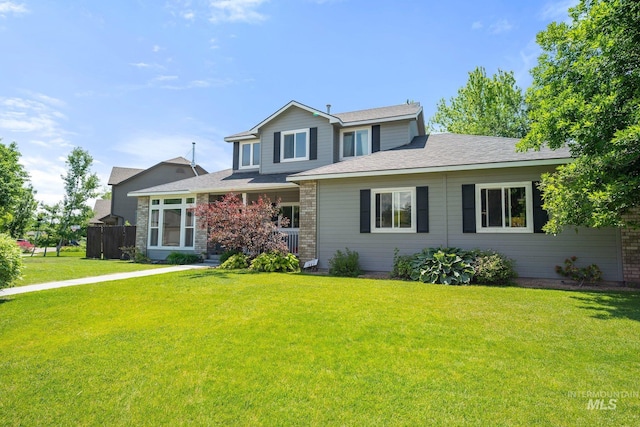 1229 N Hiltonhead Way, Eagle, ID 83616 - traditional home featuring a front yard, a shingled roof, and brick siding