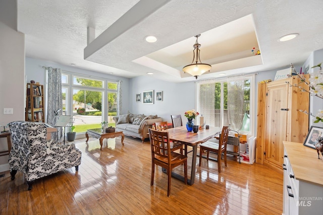 1229 N Hiltonhead Way, Eagle, ID 83616 - dining area featuring plenty of natural light, a raised ceiling, light wood-style flooring, a textured ceiling, and recessed lighting