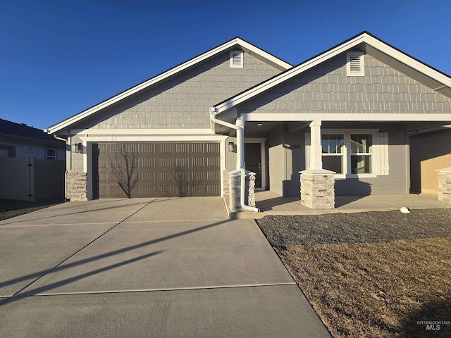 craftsman house with a garage and covered porch