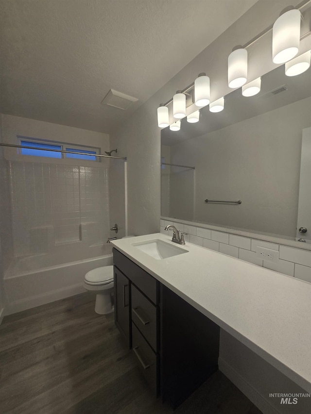 full bathroom with vanity, hardwood / wood-style floors, bathing tub / shower combination, and toilet