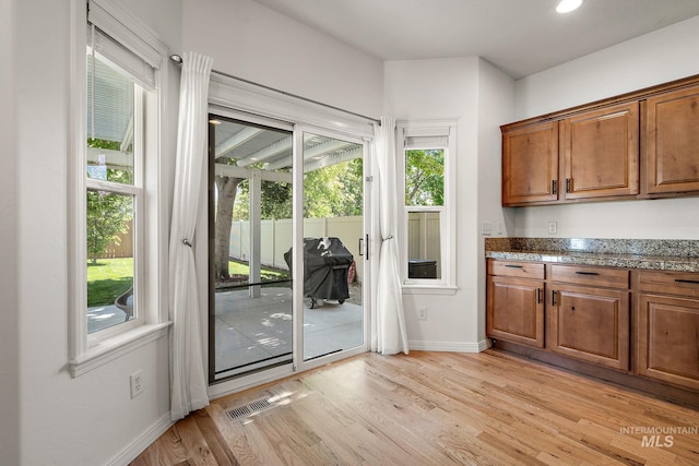 4902 N Schubert Ave, Meridian, ID 83646 - doorway with baseboards and light wood finished floors