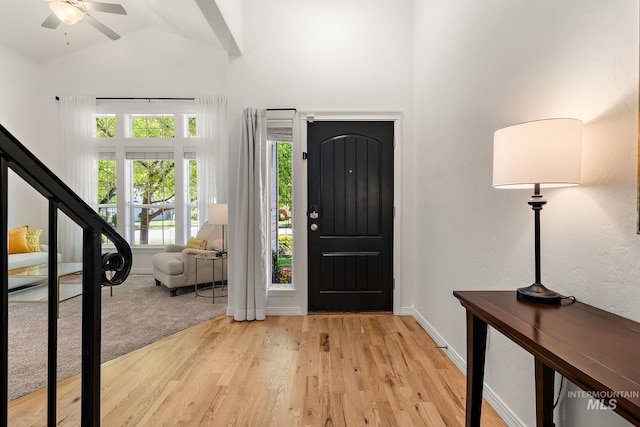 4902 N Schubert Ave, Meridian, ID 83646 - entrance foyer featuring wood finished floors, high vaulted ceiling, stairway, ceiling fan, and baseboards