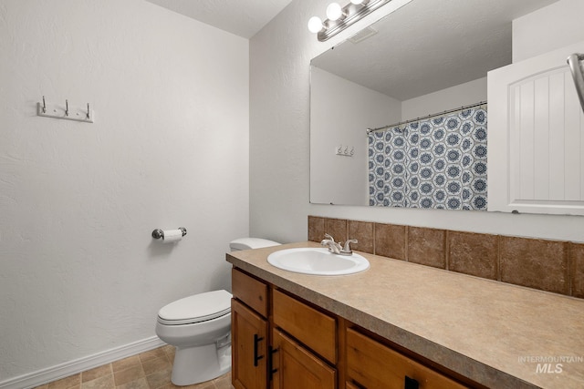 4902 N Schubert Ave, Meridian, ID 83646 - full bathroom featuring vanity, toilet, and baseboards