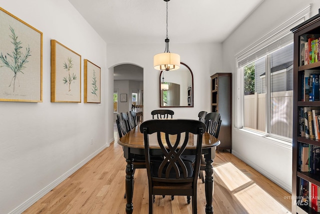 4902 N Schubert Ave, Meridian, ID 83646 - dining room featuring arched walkways, wood finished floors, and baseboards