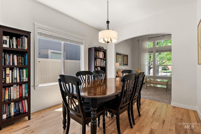 4902 N Schubert Ave, Meridian, ID 83646 - dining space featuring light wood-type flooring, arched walkways, and baseboards