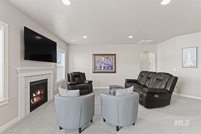 living room with visible vents, a glass covered fireplace, recessed lighting, carpet floors, and baseboards